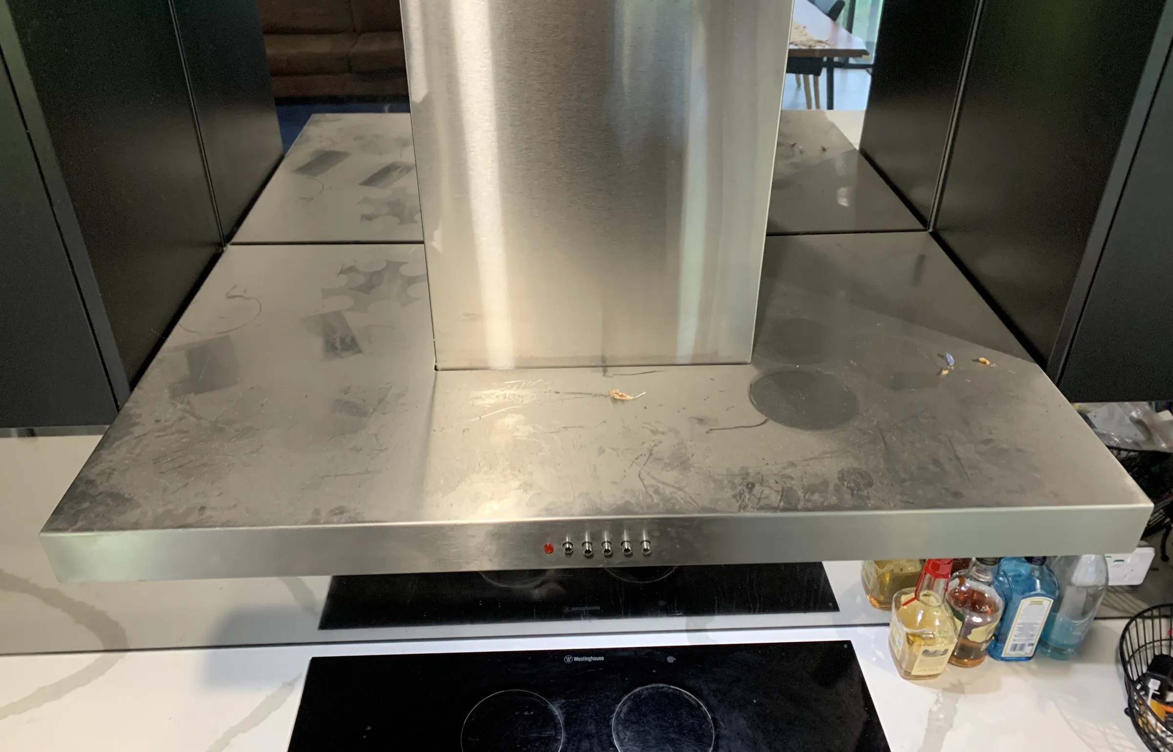 Stainless steel rangehood coated in grease film and dust before cleaning