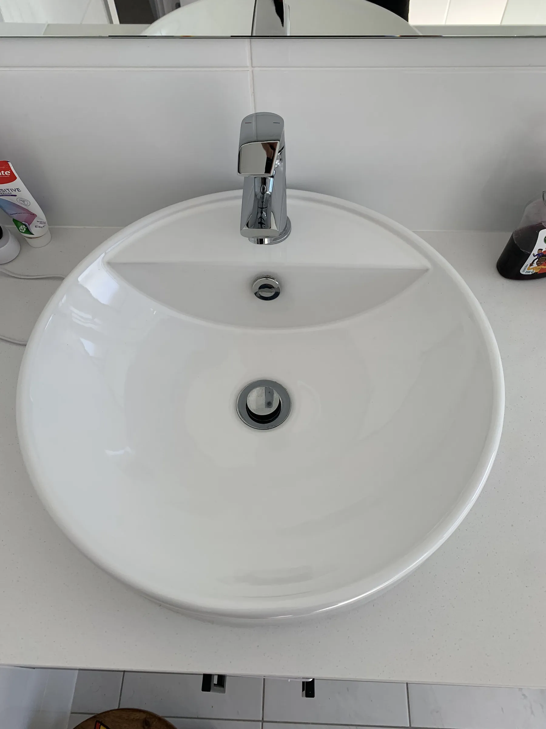 The same basin after cleaning, with a clean bowl and polished waste